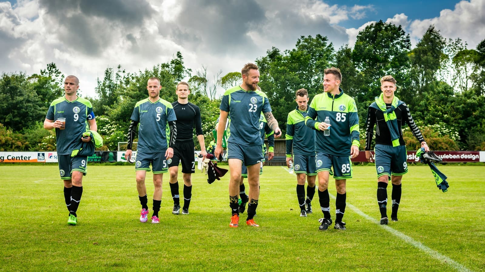 Men walking away from soccer match
