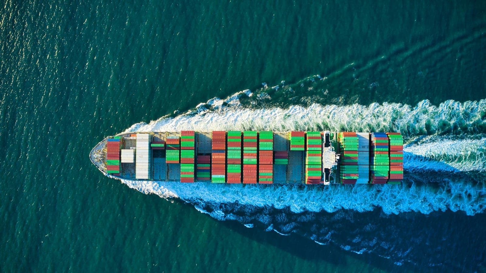 Colorful cargo ship headed out to see aerial