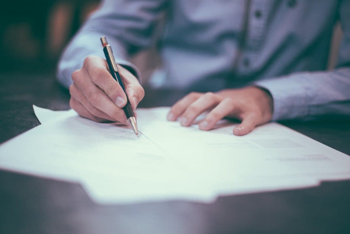 A senior consultant reviewing a structured synthesis document at a clean desk, focused and unhurried