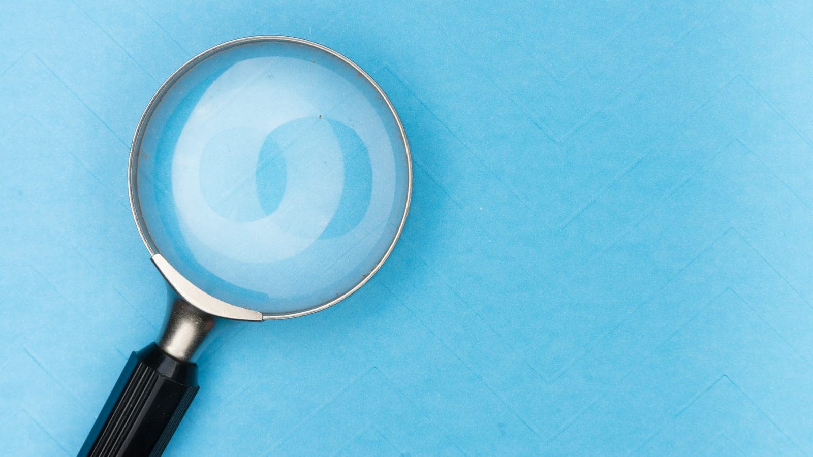 Magnifying glass on white table