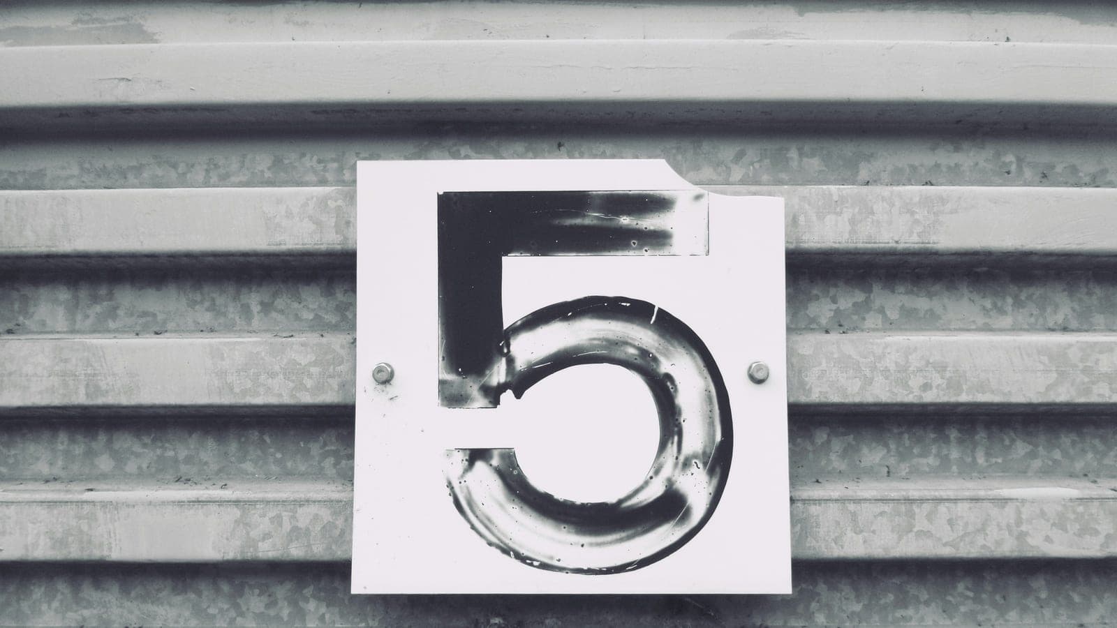 Gray tile with white number five printed text