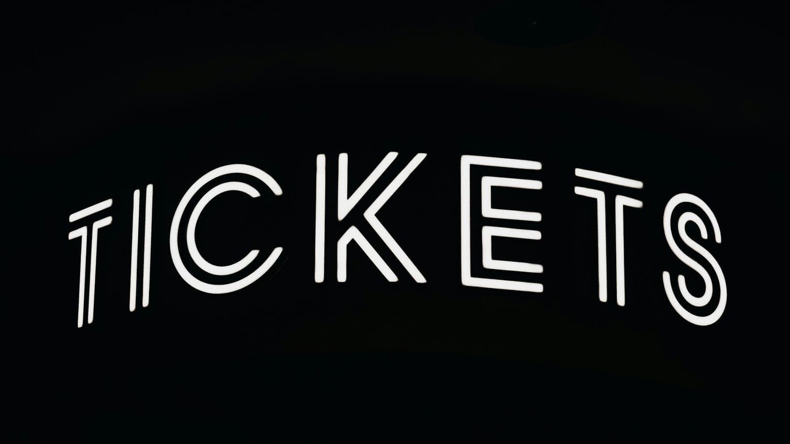 A black and white photo of a neon sign