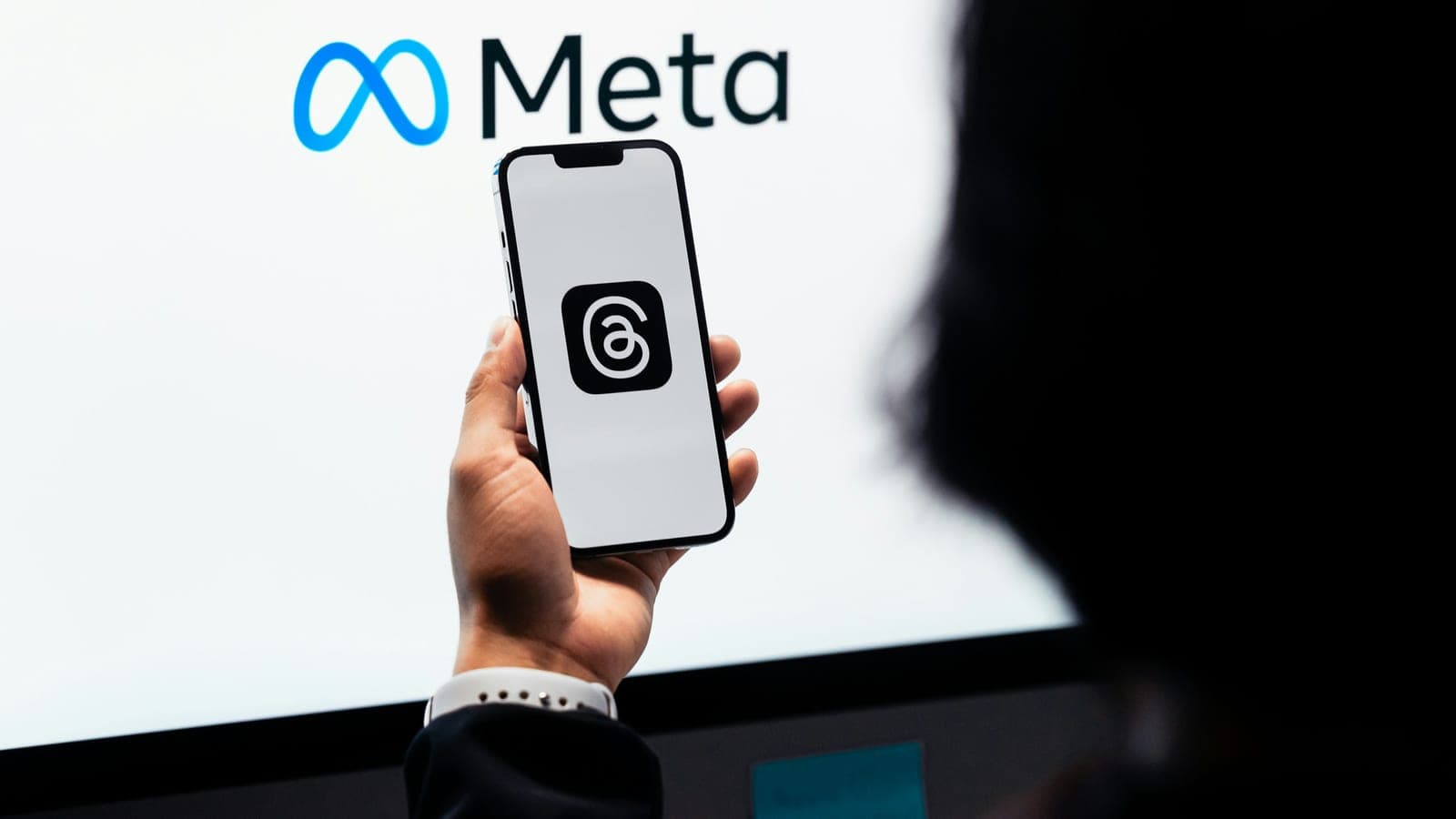 Young man using new meta threads app on smartphone