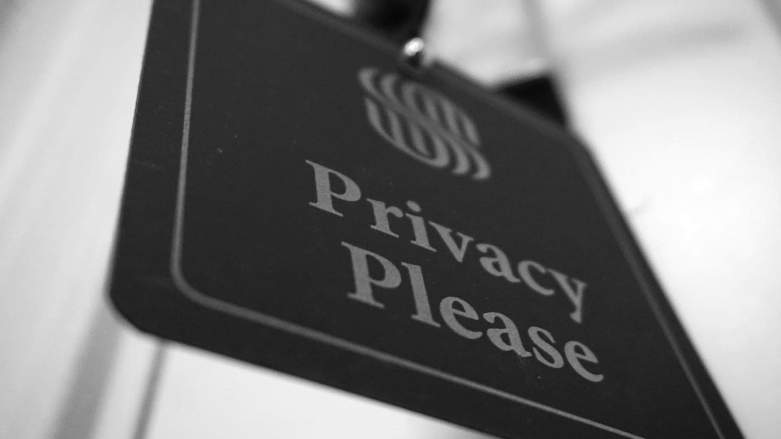 A black and white photo of a sign that says privacy please