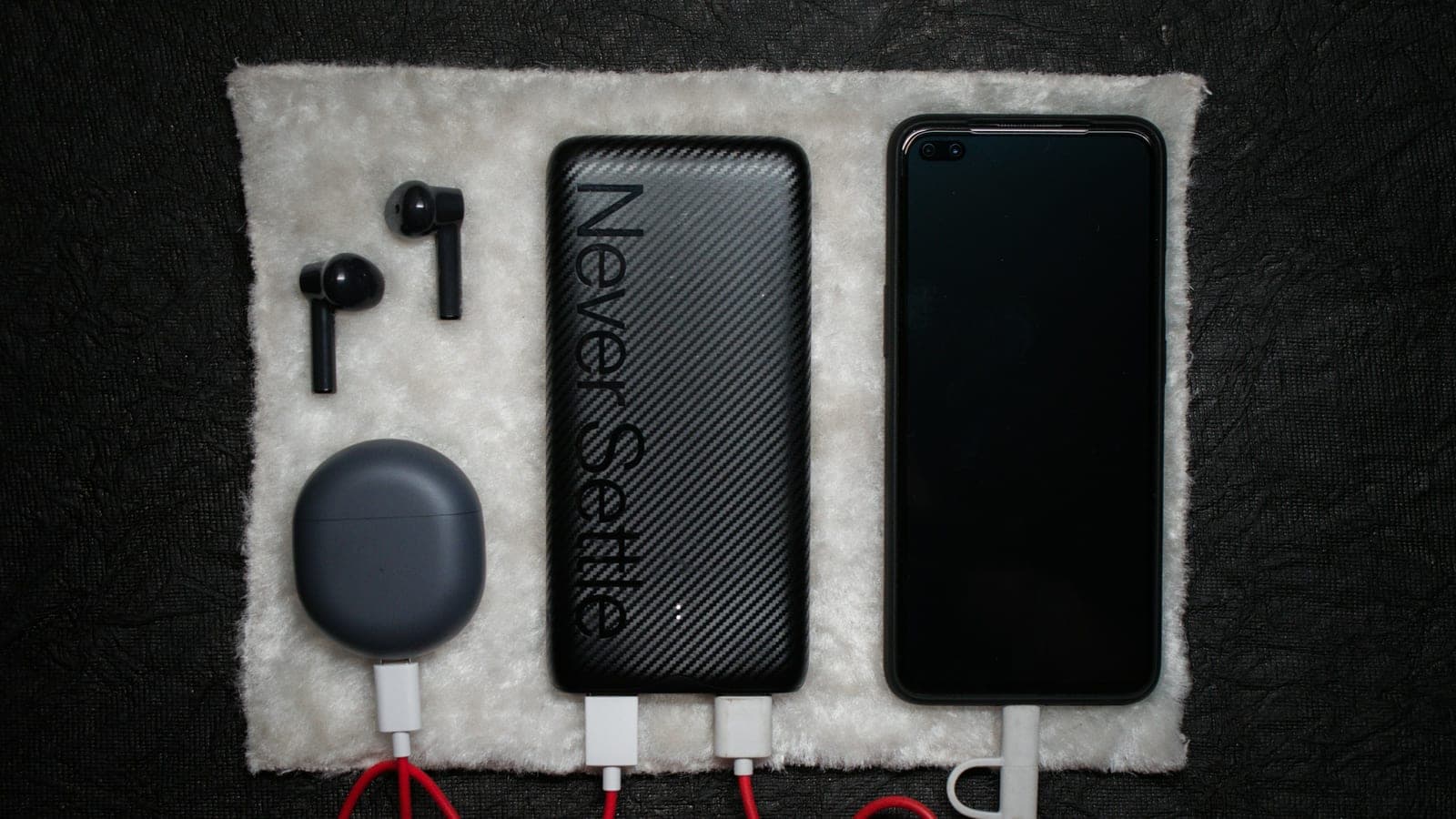 Black iphone 5 c beside white usb cable