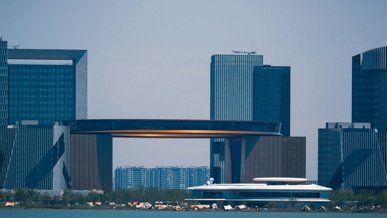 Modern buildings with a circular structure connecting them.