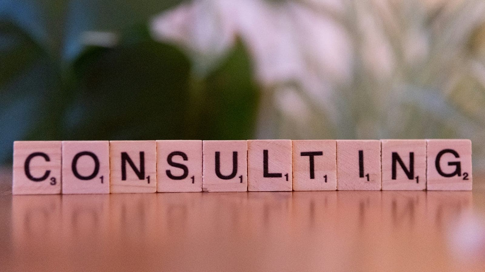 A wooden block spelling consulting on a table