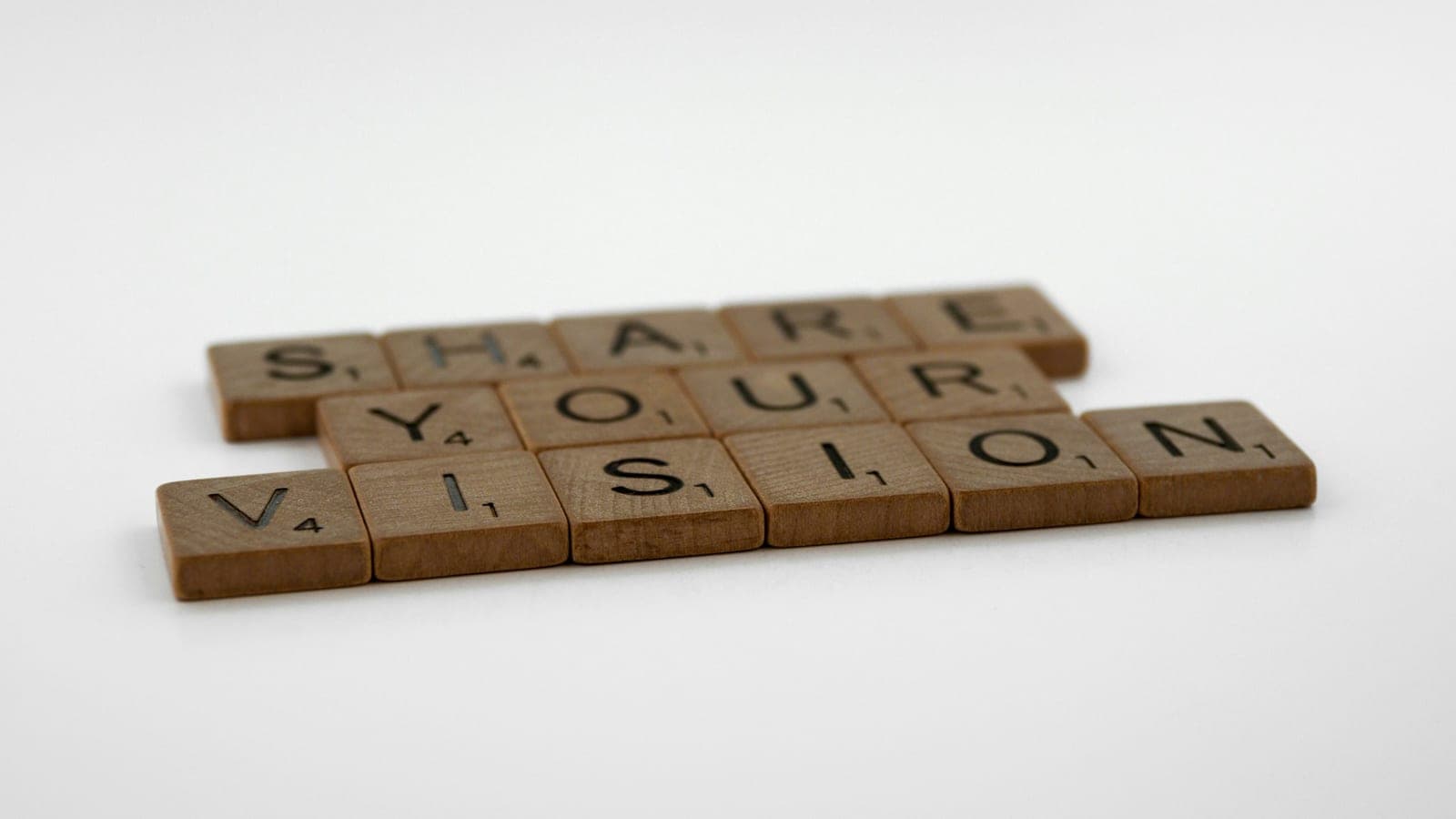 Scrabble tiles arranged on a white surface background, words, quote, letters, type, typography, design, layout, focus, bokeh, blur, photography, images, image, share your vision, shine your light, inspire people, inspire, educate, share, vision, teach, speak, converse, communication, communicate,
