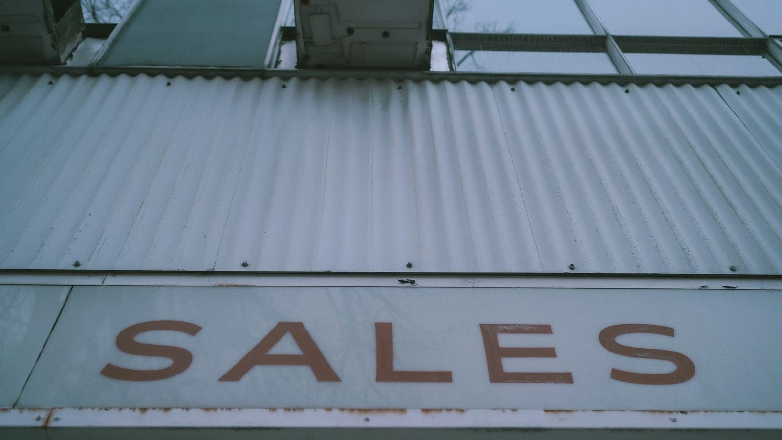 A sign that says sales on the side of a building