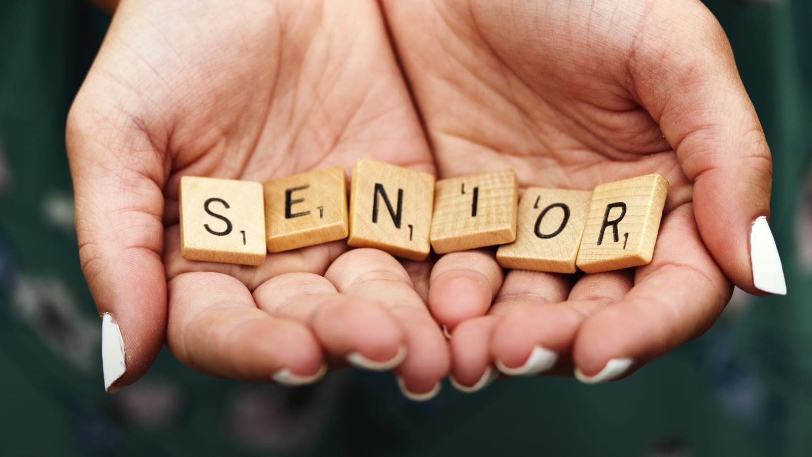 Macro shot of teen girl with manicured fingernails holding scrabble letters spelling the word SENIOR in the palms of her cupped hands.
This was my first shot during a senior portrait session a few years ago and taken spur of the moment in the parking lot at Kohler-Andrae State Park in Sheboygan, Wisconsin.