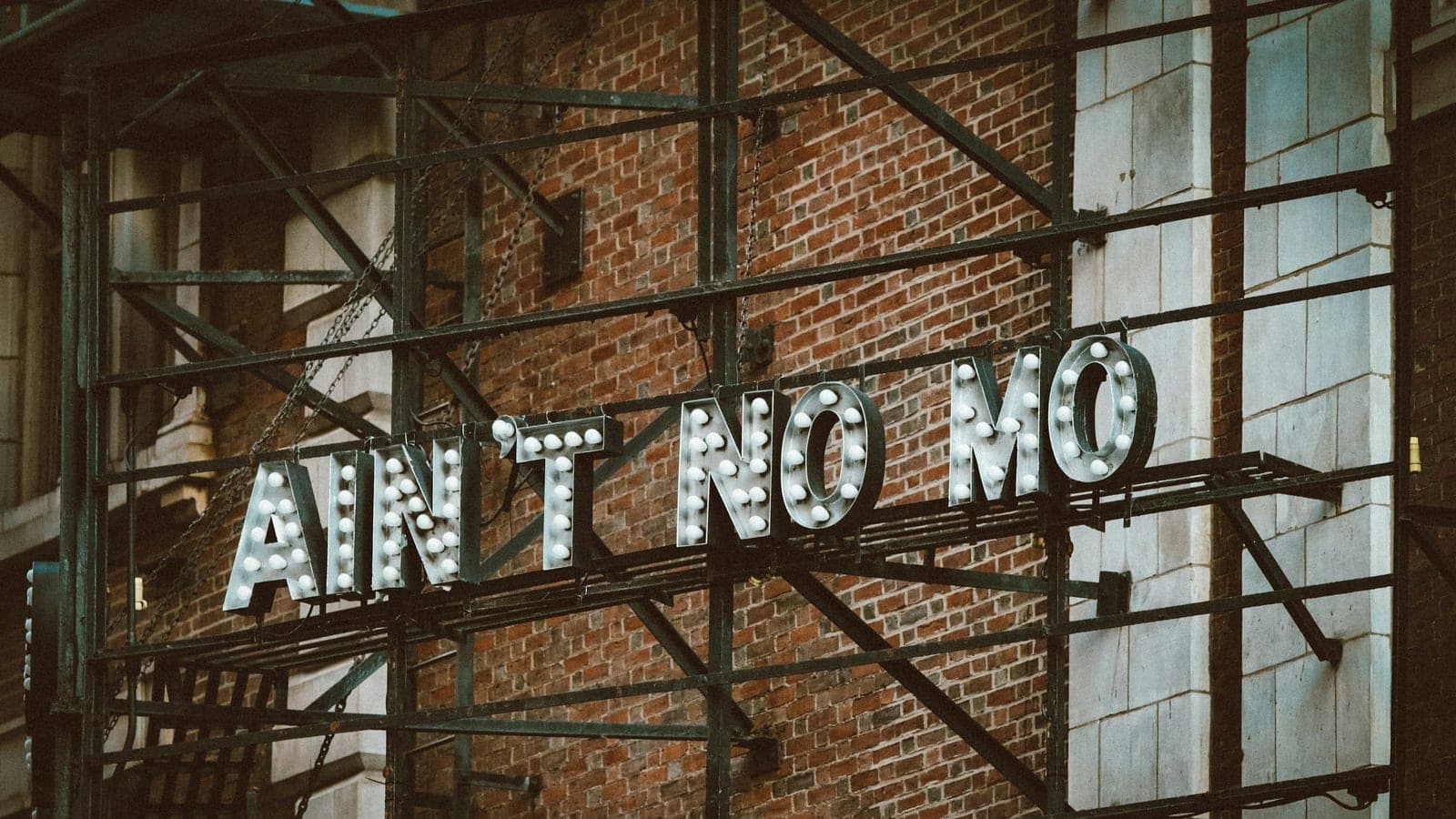 A brick wall with a sign on it